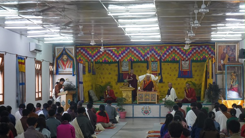 A full hall of students during a prayer gathering